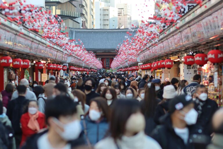 Crowds in Nakamise Shopping Street, Asakusa, Tokyo during a festival. Vibrant and lively scene.